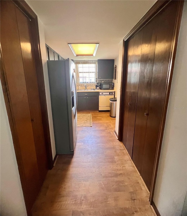 35140 Whispering Oaks Blvd, Dade City, FL 33523 - hallway with light wood-style floors and a sink