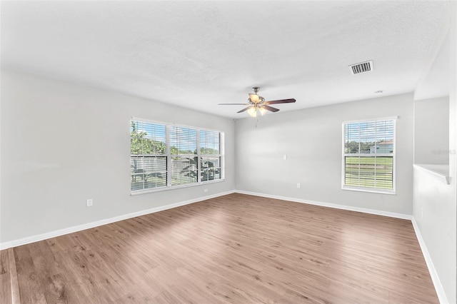 10523 Boyette Creek Blvd, Riverview, FL 33569 - unfurnished room with wood finished floors, a ceiling fan, and a textured ceiling