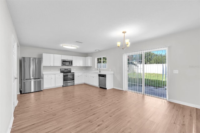 10523 Boyette Creek Blvd, Riverview, FL 33569 - kitchen featuring stainless steel appliances, a chandelier, light wood-style flooring, and light countertops