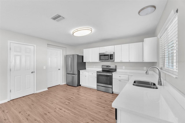 10523 Boyette Creek Blvd, Riverview, FL 33569 - kitchen with stainless steel appliances, light wood-style flooring, light countertops, and white cabinets