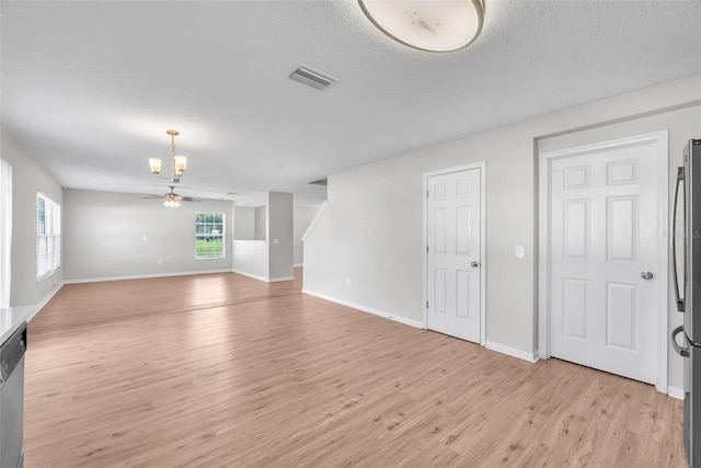 10523 Boyette Creek Blvd, Riverview, FL 33569 - unfurnished living room featuring light wood finished floors, a chandelier, and ceiling fan