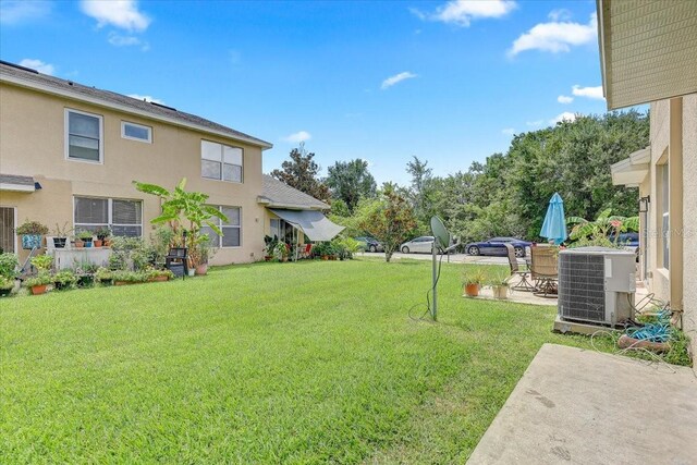 9907 Carlsdale Dr, Riverview, FL 33578 - view of green lawn with a patio