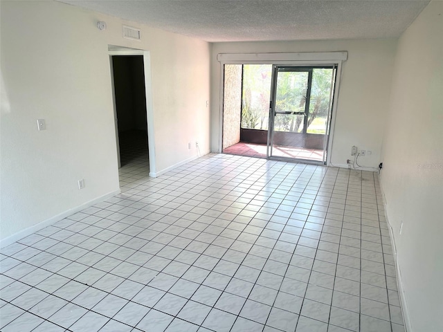 6342 Newtown Cir Unit A4, Tampa, FL 33615 - spare room featuring a textured ceiling, light tile patterned floors, and a smoke detector