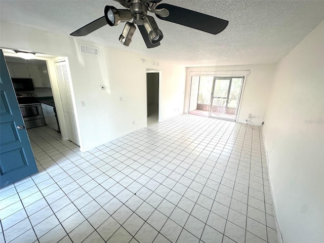 6342 Newtown Cir Unit A4, Tampa, FL 33615 - empty room featuring light tile patterned floors, a ceiling fan, and a textured ceiling