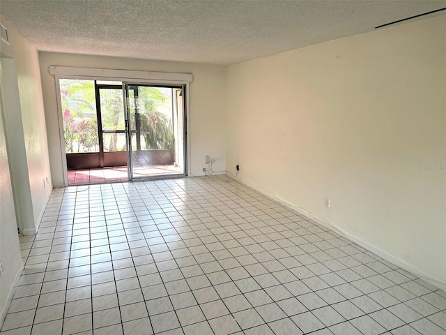 6342 Newtown Cir Unit A4, Tampa, FL 33615 - empty room with a textured ceiling and light tile patterned floors
