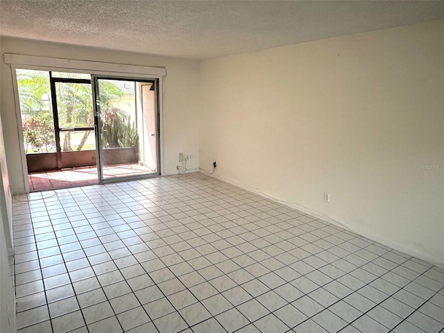 6342 Newtown Cir Unit A4, Tampa, FL 33615 - unfurnished room with tile patterned floors and a textured ceiling