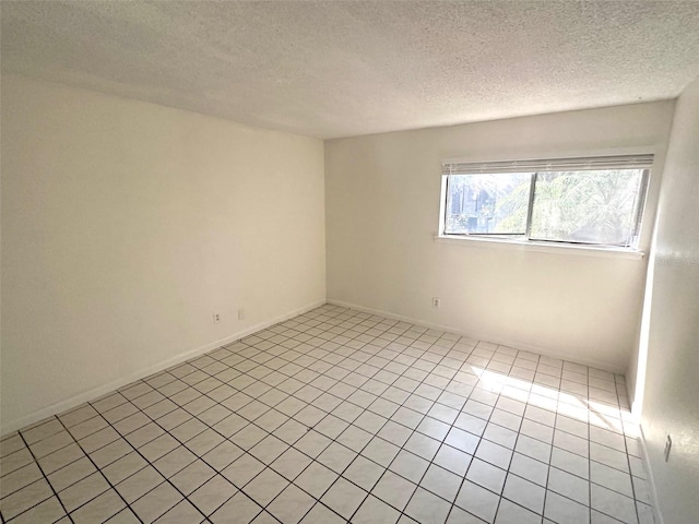 6342 Newtown Cir Unit A4, Tampa, FL 33615 - empty room featuring a textured ceiling and light tile patterned floors