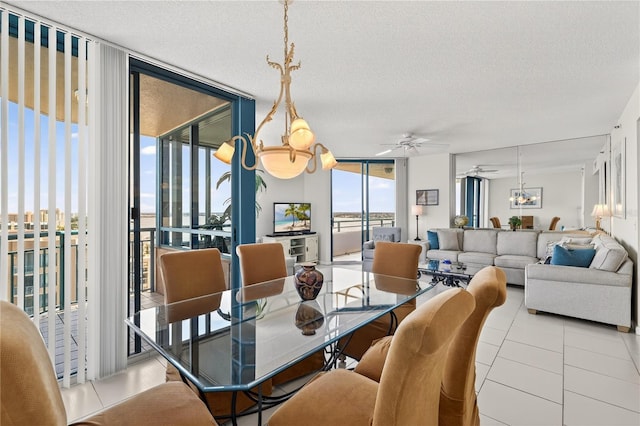 1540 Gulf Blvd Unit 2107, Clearwater Beach, FL 33767 - dining space with a wall of windows, healthy amount of natural light, a ceiling fan, tile patterned flooring, and a textured ceiling