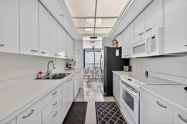 1540 Gulf Blvd Unit 2107, Clearwater Beach, FL 33767 - kitchen with white appliances, white cabinetry, light countertops, and light tile patterned floors