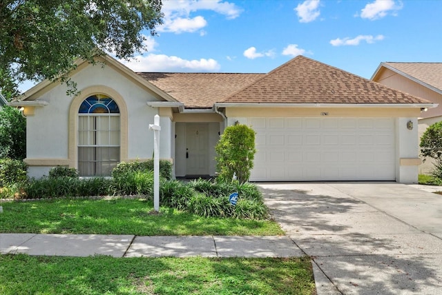 1741 Elk Spring Dr, Brandon, FL 33511 - view of front of home featuring roof with shingles, stucco siding, a garage, and concrete driveway