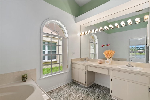1741 Elk Spring Dr, Brandon, FL 33511 - full bathroom featuring double vanity, a garden tub, healthy amount of natural light, and marble look tile flooring