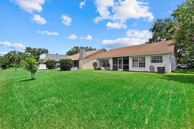 1741 Elk Spring Dr, Brandon, FL 33511 - back of house featuring stucco siding, a lawn, a sunroom, and a chimney