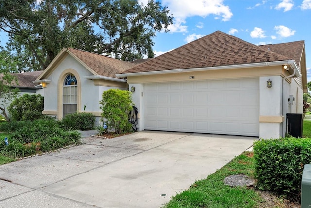 1741 Elk Spring Dr, Brandon, FL 33511 - view of front of house featuring stucco siding, a shingled roof, concrete driveway, and an attached garage