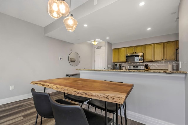 1108 N Franklin St Unit 602, Tampa, FL 33602 - kitchen featuring appliances with stainless steel finishes, dark wood-style floors, tasteful backsplash, brown cabinets, and recessed lighting