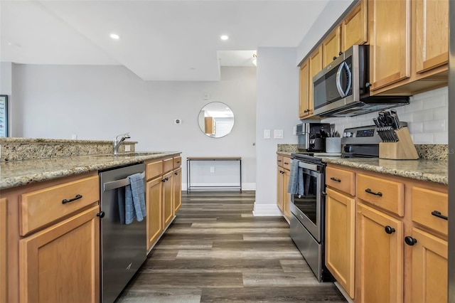1108 N Franklin St Unit 602, Tampa, FL 33602 - kitchen featuring stainless steel appliances, dark wood-type flooring, decorative backsplash, light stone countertops, and recessed lighting