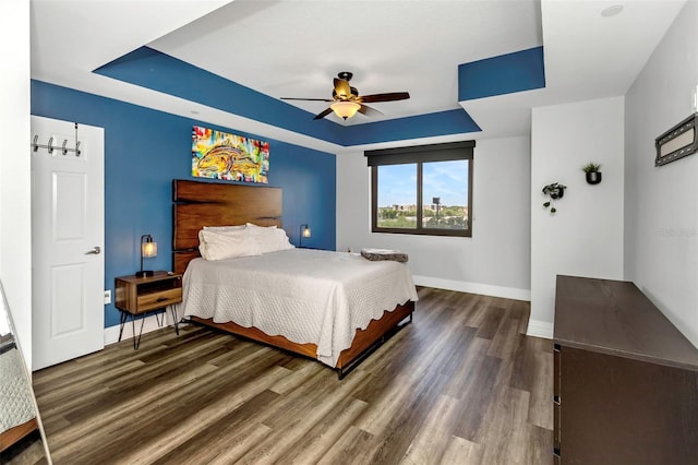 1108 N Franklin St Unit 602, Tampa, FL 33602 - bedroom featuring wood finished floors, a raised ceiling, and a ceiling fan