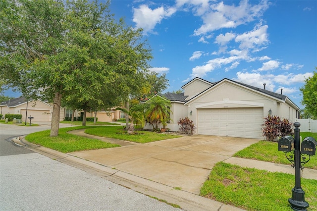12721 Avelar Creek Dr, Riverview, FL 33578 - view of front of property featuring stucco siding, an attached garage, driveway, and a front lawn