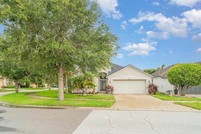 12721 Avelar Creek Dr, Riverview, FL 33578 - view of property hidden behind natural elements featuring stucco siding, driveway, a garage, and a front yard