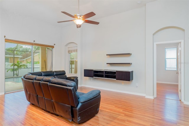 12721 Avelar Creek Dr, Riverview, FL 33578 - living room with ceiling fan, light wood finished floors, and arched walkways