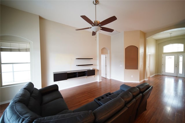 12721 Avelar Creek Dr, Riverview, FL 33578 - living area featuring arched walkways, dark wood-style floors, ceiling fan, and high vaulted ceiling