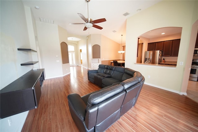 12721 Avelar Creek Dr, Riverview, FL 33578 - living room featuring arched walkways, light wood-type flooring, a ceiling fan, and lofted ceiling
