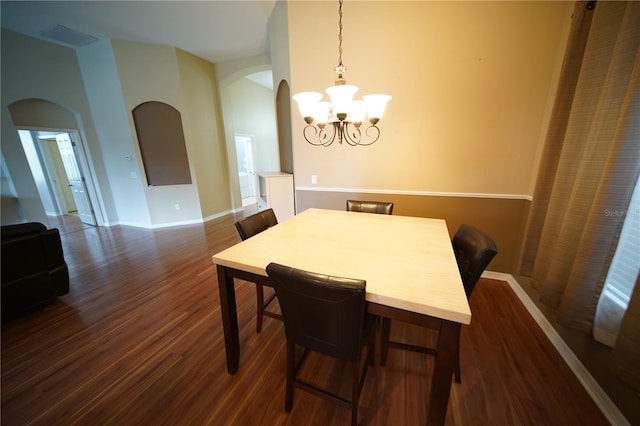 12721 Avelar Creek Dr, Riverview, FL 33578 - dining area featuring arched walkways, dark wood-type flooring, and a chandelier
