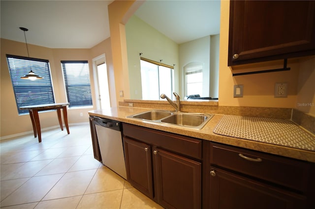 12721 Avelar Creek Dr, Riverview, FL 33578 - kitchen with stainless steel dishwasher, plenty of natural light, light tile patterned flooring, and decorative light fixtures