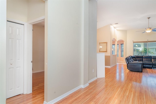 12721 Avelar Creek Dr, Riverview, FL 33578 - hallway featuring light wood-type flooring and arched walkways