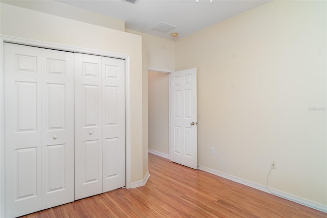 12721 Avelar Creek Dr, Riverview, FL 33578 - unfurnished bedroom featuring light wood-type flooring and a closet