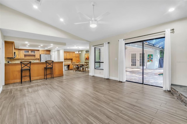 910 Kingscote Ct, Safety Harbor, FL 34695 - living area with light wood-style floors, ceiling fan, recessed lighting, vaulted ceiling, and french doors
