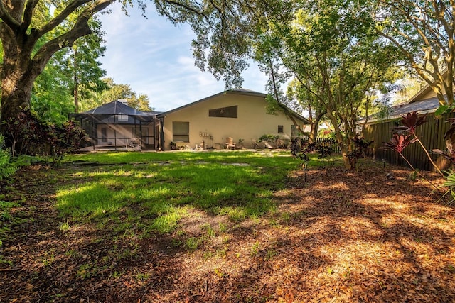 910 Kingscote Ct, Safety Harbor, FL 34695 - view of grassy yard with glass enclosure