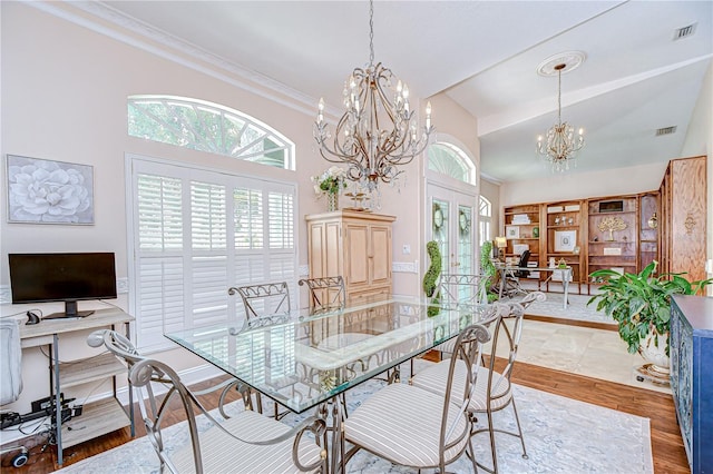 19307 Wind Dancer St, Lutz, FL 33558 - dining space with a chandelier, french doors, high vaulted ceiling, crown molding, and a desk