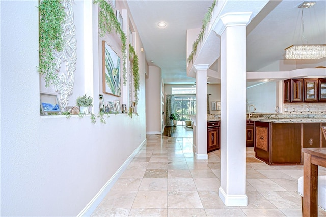 19307 Wind Dancer St, Lutz, FL 33558 - corridor with ornate columns and light tile patterned floors