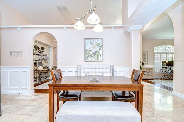 19307 Wind Dancer St, Lutz, FL 33558 - dining area with a decorative wall, a wainscoted wall, and arched walkways