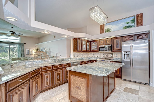 19307 Wind Dancer St, Lutz, FL 33558 - kitchen featuring appliances with stainless steel finishes, light stone counters, glass insert cabinets, backsplash, and recessed lighting