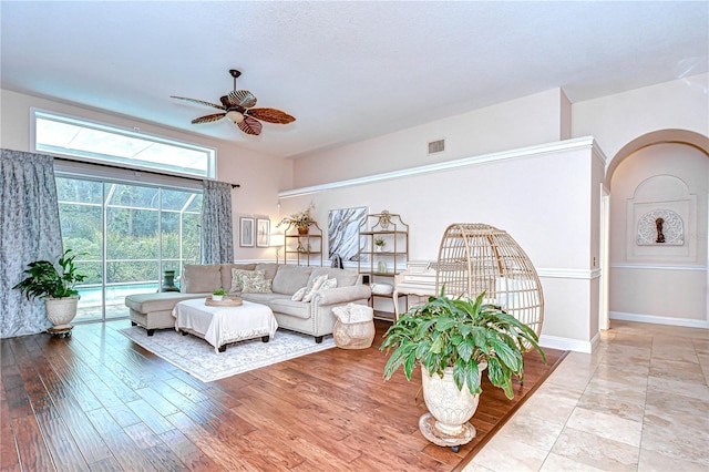 19307 Wind Dancer St, Lutz, FL 33558 - living room featuring ceiling fan, arched walkways, and wood finished floors