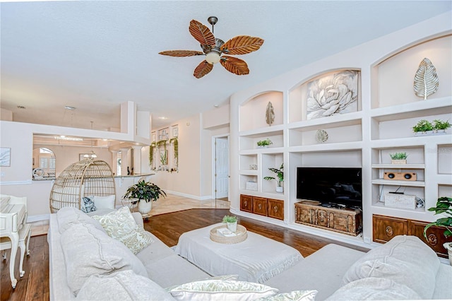 19307 Wind Dancer St, Lutz, FL 33558 - living room featuring ceiling fan, wood finished floors, and built in shelves