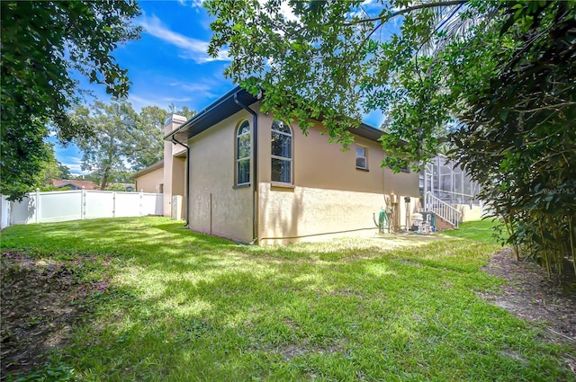 2504 Oak Landing Dr, Brandon, FL 33511 - view of home's exterior with stucco siding, a chimney, and a gate