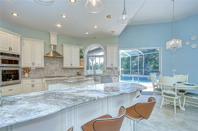 2504 Oak Landing Dr, Brandon, FL 33511 - kitchen with tasteful backsplash, recessed lighting, light stone countertops, decorative light fixtures, and a kitchen bar