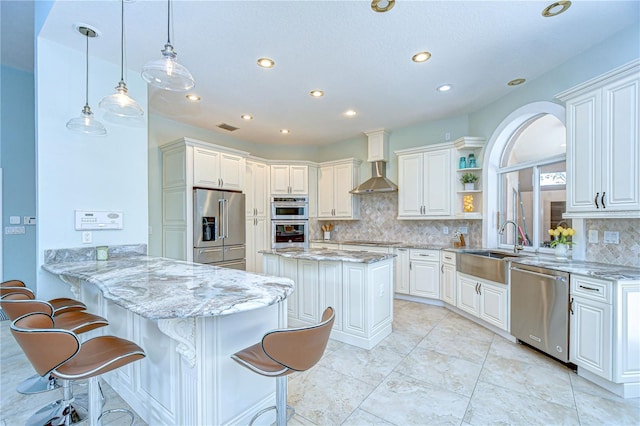 2504 Oak Landing Dr, Brandon, FL 33511 - kitchen with stainless steel appliances, wall chimney range hood, a peninsula, recessed lighting, and backsplash