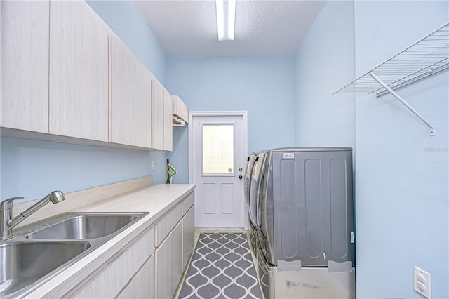 2504 Oak Landing Dr, Brandon, FL 33511 - laundry room featuring cabinet space, washer / dryer, and a textured ceiling