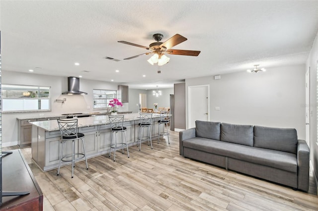 446 Eagle Cir, Casselberry, FL 32707 - living room featuring light wood-style flooring, a ceiling fan, a textured ceiling, a chandelier, and recessed lighting
