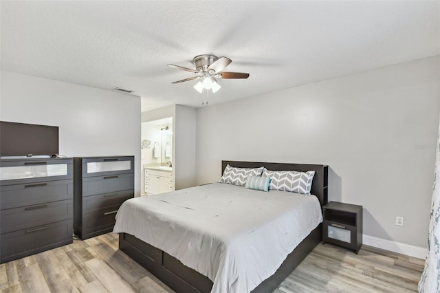 446 Eagle Cir, Casselberry, FL 32707 - bedroom featuring light wood finished floors, ensuite bathroom, and a ceiling fan