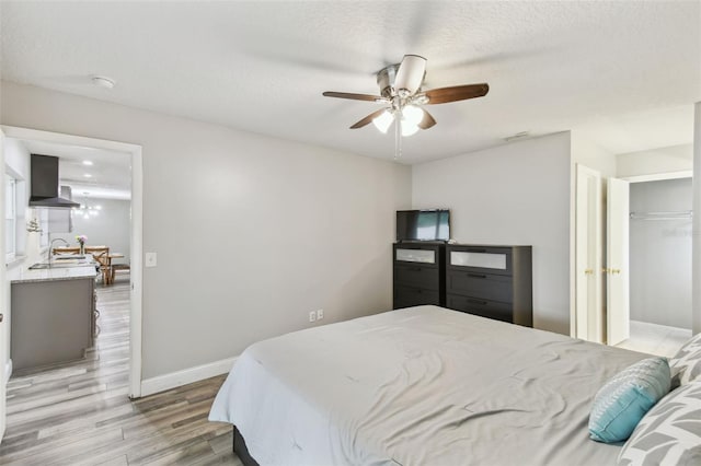 446 Eagle Cir, Casselberry, FL 32707 - bedroom with light wood-style floors, a ceiling fan, and a textured ceiling