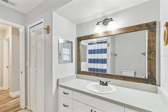 446 Eagle Cir, Casselberry, FL 32707 - bathroom featuring vanity, a closet, wood finished floors, and a shower with curtain