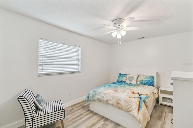 446 Eagle Cir, Casselberry, FL 32707 - bedroom with light wood-style flooring, ceiling fan, and a textured ceiling