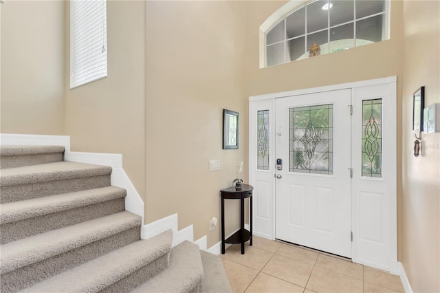 886 Suffolk Pl, Davenport, FL 33896 - entrance foyer with light tile patterned floors, healthy amount of natural light, stairs, and a towering ceiling