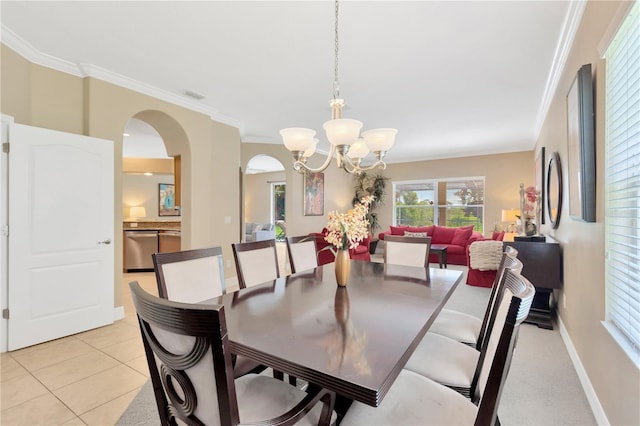 886 Suffolk Pl, Davenport, FL 33896 - dining space featuring arched walkways, ornamental molding, a chandelier, and light tile patterned flooring