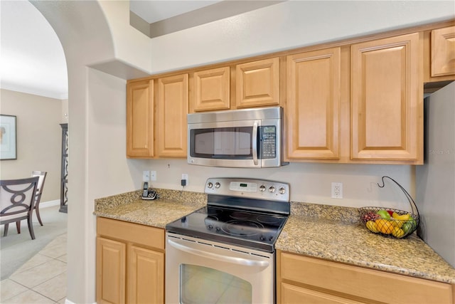 886 Suffolk Pl, Davenport, FL 33896 - kitchen featuring stainless steel appliances, light brown cabinetry, light carpet, and light stone counters