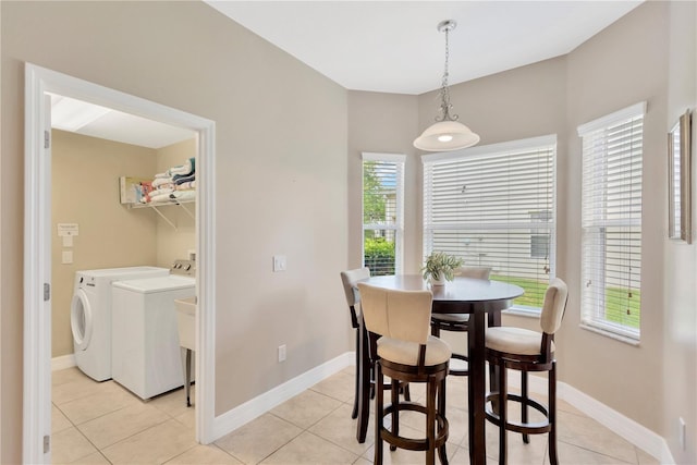 886 Suffolk Pl, Davenport, FL 33896 - dining space featuring washing machine and clothes dryer and light tile patterned flooring